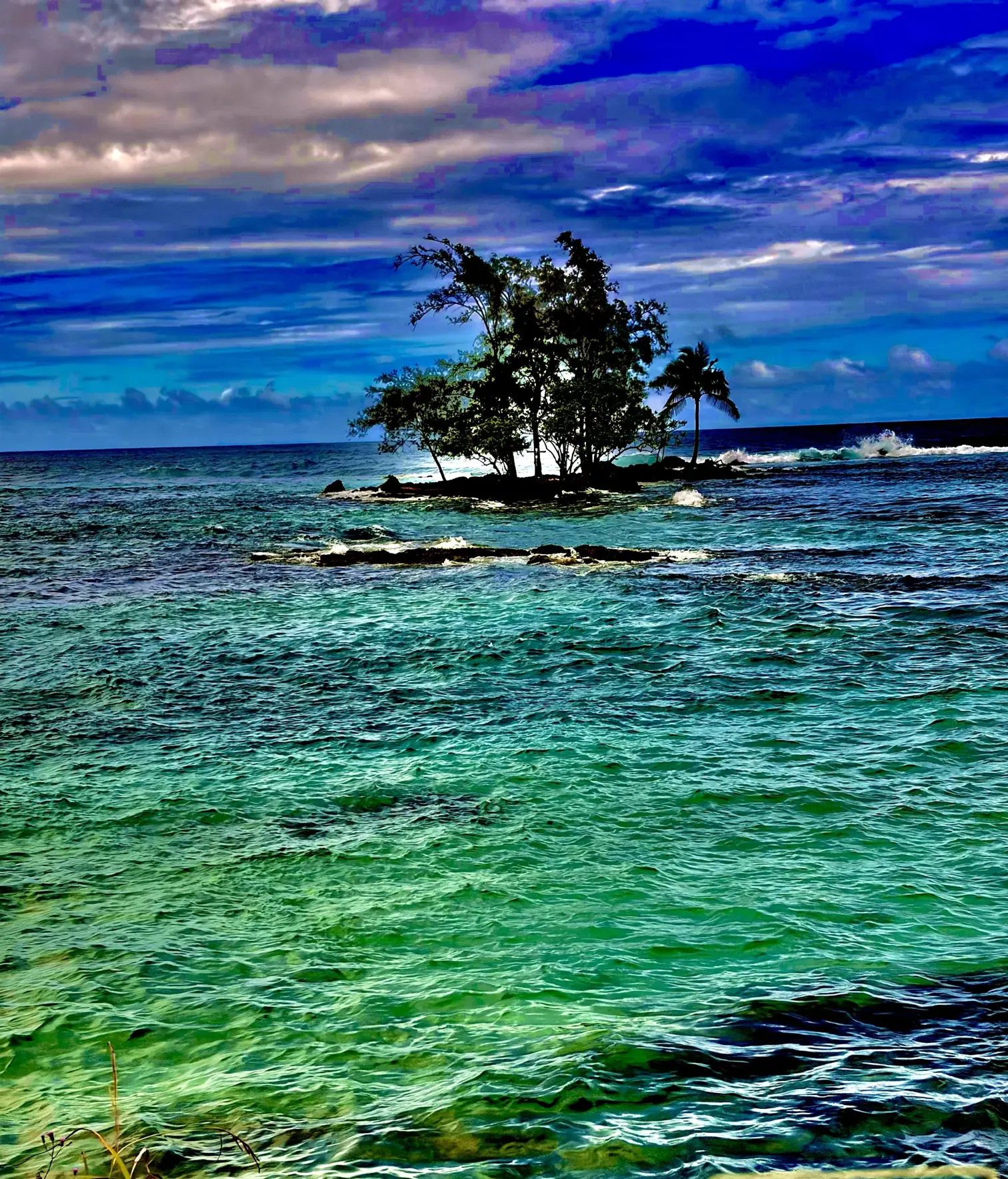 Turquoise lagoon waters with a small tree-covered island